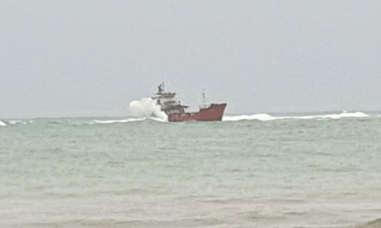 Tanker, probably in load, aground on coastal reefs, Java sea